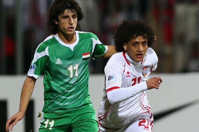 Humam Tariq takes on Emirati player Omar Abdul Rahman in a 21st Gulf Cup match. Picture: Getty