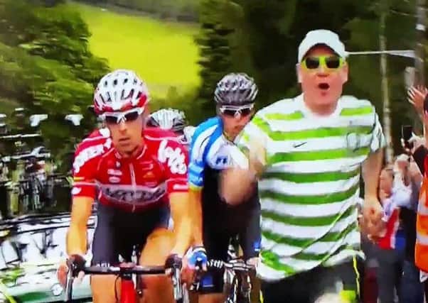 The unnamed spectator in his Celtic top jogging along at the front of the Tour De France. Picture: Contributed