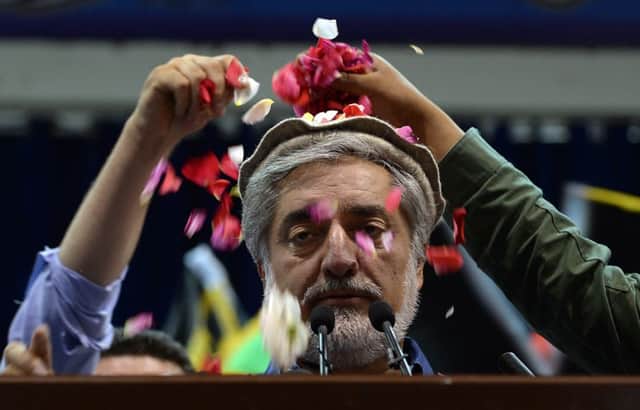Abdullah Abdullah is showered with rose petals at a rally in Kabul yesterday. Picture: Getty