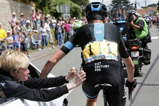 Team Sky rider Chris Froome is given medical treatment to his left hip by medical staff. Picture: Reuters