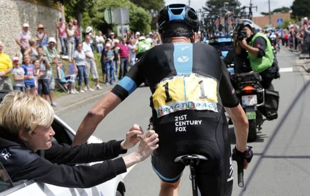 Team Sky rider Chris Froome is given medical treatment to his left hip by medical staff. Picture: Reuters