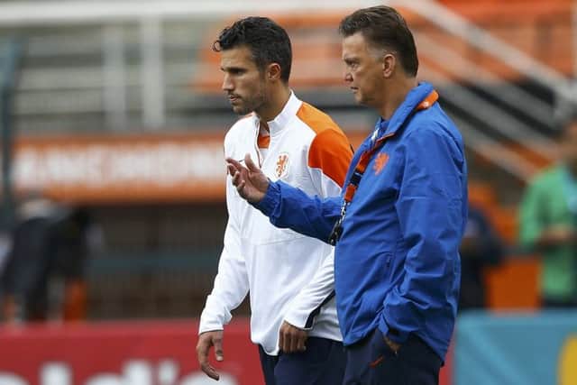 Robin van Persie and Louis van Gaal in conversation during yesterdays training session. Picture: Reuters