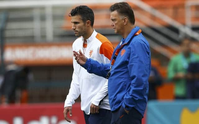 Robin van Persie and Louis van Gaal in conversation during yesterdays training session. Picture: Reuters