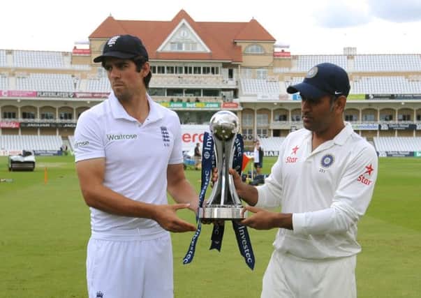 Skippers Alastair Cook and MS Dhoni pose with Pataudi Trophy which will be contested by England and India. Picture: AP