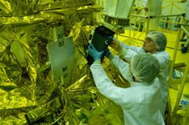 Clyde Space engineers prepare the satellite. Picture: Contributed