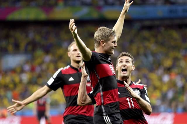 Toni Kroos celebrates with Miroslav Klose after scoring his side's third goal. Picture: AP
