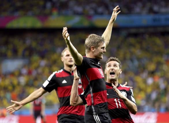 Toni Kroos celebrates with Miroslav Klose after scoring his side's third goal. Picture: AP