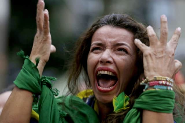 A Brazil soccer fan screams as Germany defeats her team 7-1 in the semi-final World Cup match. Picture: AP