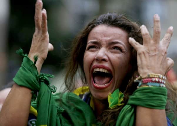 A Brazil soccer fan screams as Germany defeats her team 7-1 in the semi-final World Cup match. Picture: AP