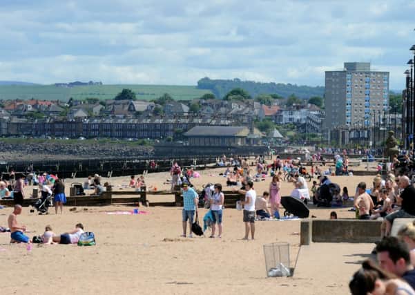 People take advantage of the warm weather at Portabello beach. Picture: TSPL