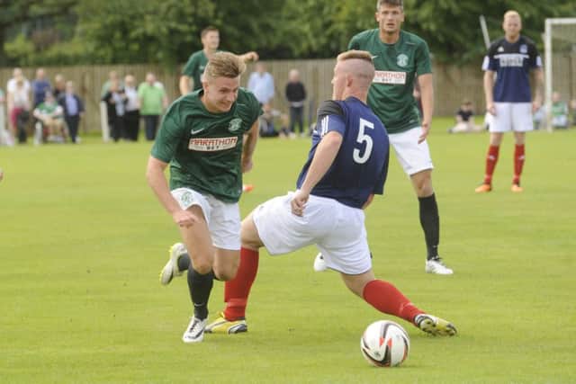 Jason Cummings takes on Jack Blaikie of Vale of Leithen in Hibernian's 4-0 pre-season victory in Innerleithen. Picture: Greg Macvean