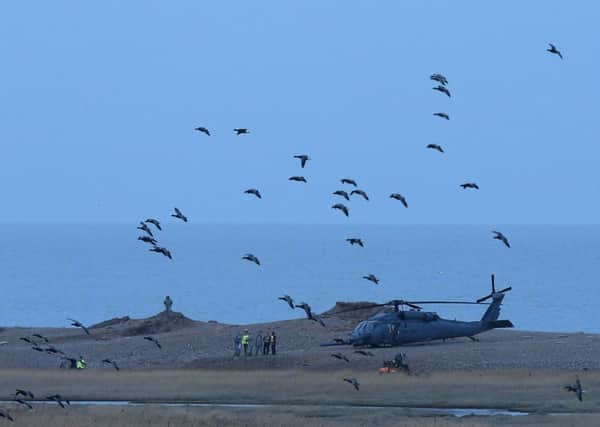 Military personnel and emergency services attend the scene after a US Air Force helicopter crashed in January. Picture: Getty