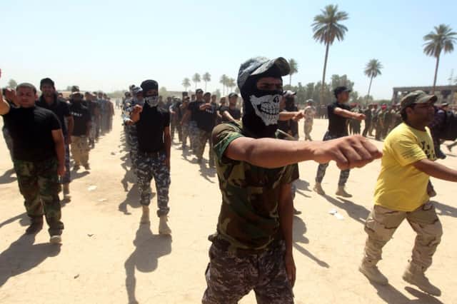 Shiite volunteers from the Iraqi Ketaeb (brigade) Hezbollah drill in preparation for joining the Iraqi army. Picture: Getty