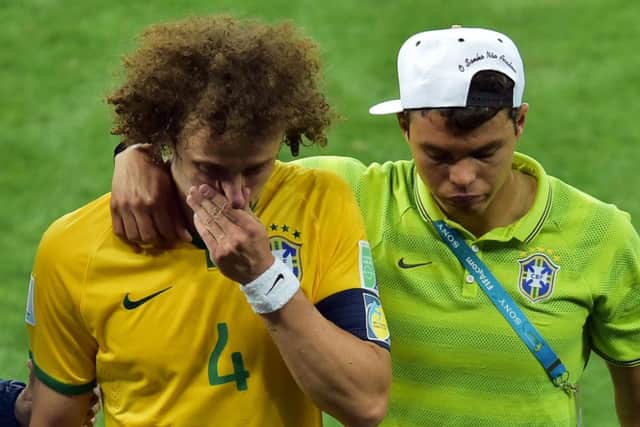 Brazils defender David Luiz, left, is consoled by Brazils suspended captain Thiago Silva. Picture: AFP/Getty