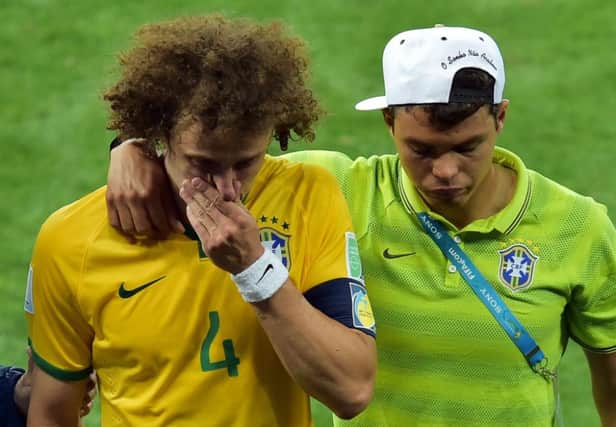 Brazils defender David Luiz, left, is consoled by Brazils suspended captain Thiago Silva. Picture: AFP/Getty