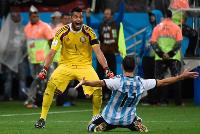 Sergio Romero, left, celebrates with Maxi Rodriguez after the goalkeepers penalty shoot-out heroics. Picture: Getty Images