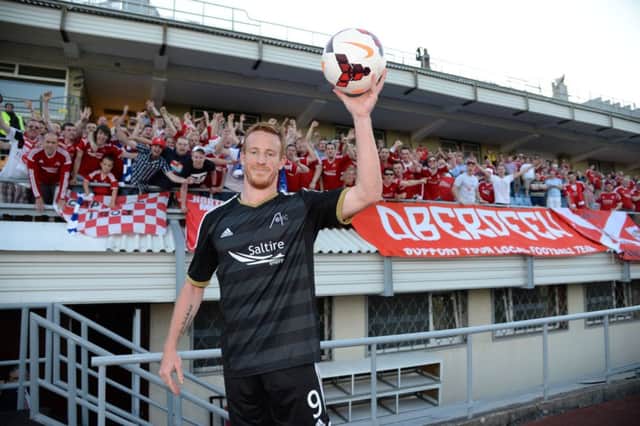 Adam Rooney celebrates at full time with the match ball. Picture: SNS