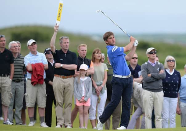 Pressure player: Bradley Neil plays an iron shot during the final round of the Amateur Championship at Portrush on 22 June, which ended with the Blairgowrie teenager lifting the competitions magnificent trophy, below left. Photographs: Tony Marshall/R&A/Getty