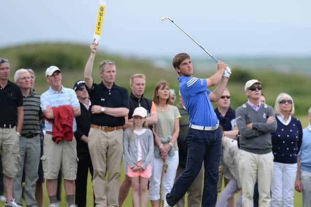 Pressure player: Bradley Neil plays an iron shot during the final round of the Amateur Championship at Portrush on 22 June, which ended with the Blairgowrie teenager lifting the competitions magnificent trophy, below left. Photographs: Tony Marshall/R&A/Getty