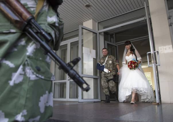 Life goes on ... platoon commander Arsen Pavlov, and Elena Kolenkina after their wedding ceremony in the city of Donetsk. Picture: AP