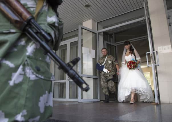 Life goes on ... platoon commander Arsen Pavlov, and Elena Kolenkina after their wedding ceremony in the city of Donetsk.  Picture: AP