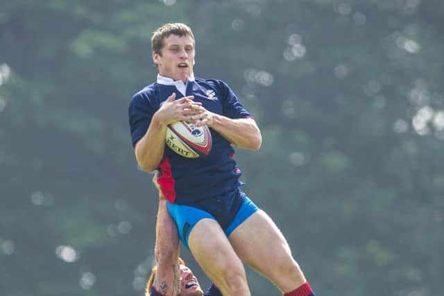 New skills: Mark Bennett gets a lift from Roddy Grant as he learns the sevens ropes ahead of the Games. Photograph: Craig Foy/SNS
