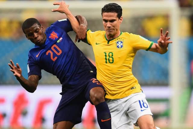 Georginio Wijnaldum of the Netherlands and Hernanes of Brazil compete for the ball. Picture: Getty
