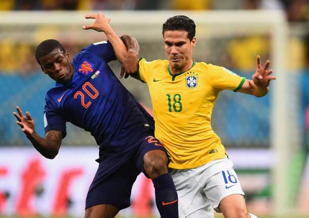 Georginio Wijnaldum of the Netherlands and Hernanes of Brazil compete for the ball. Picture: Getty