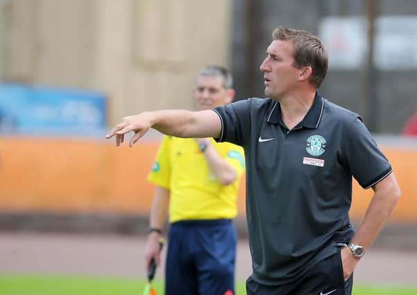 Hibernian manager Alan Stubbs urges his side on from the dugout. Picture: Gordon Fraser