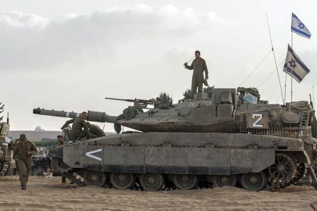 Israeli soldiers on duty on top of a tank at the border with the Gaza Strip. Picture: Getty