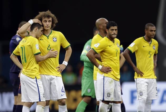Oscar, left, and David Luiz console each other while striker Hulk, centre and defender Fernandinho, look desolate. Picture: AP