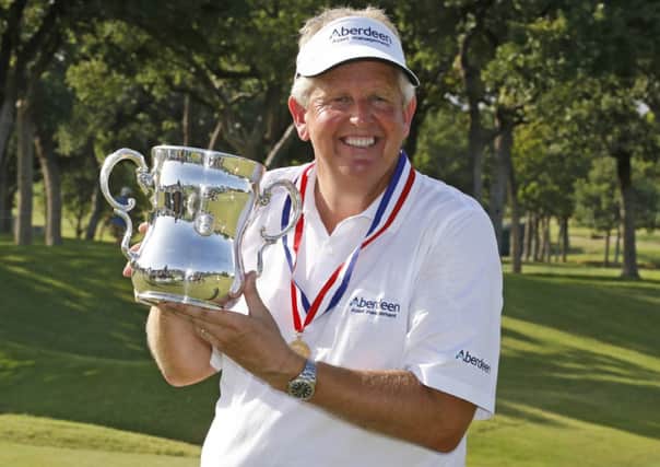 Colin Montgomerie poses with the Francis D. Ouimet Memorial Trophy after winning the U.S. Senior Open golf tournament at Oak Tree. Picture: AP