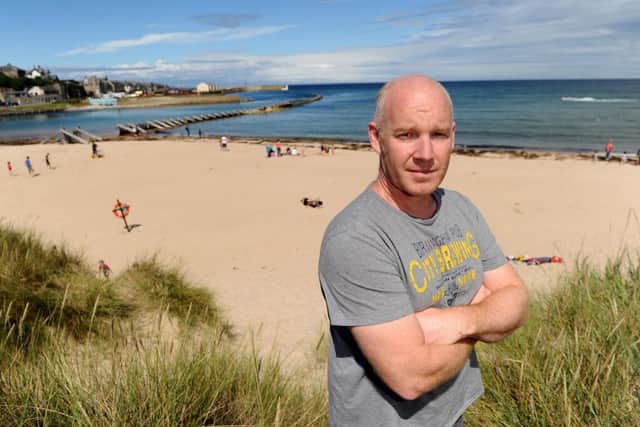 Rich Stinson at Lossiemouth beach where he dived in to save the life of a young girl. Picture: Hemedia