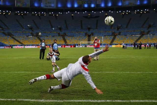 Lukas Podolski plays football with his his son Louis Gabriel Podolski after the final. Picture: Reuters