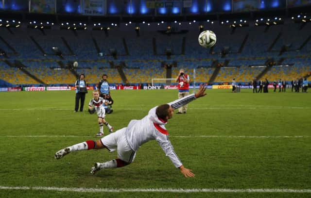 Lukas Podolski plays football with his his son Louis Gabriel Podolski after the final. Picture: Reuters