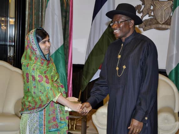 Malala Yousafzai shakes hands with Goodluck Jonathan yesterday. Picture: AP
