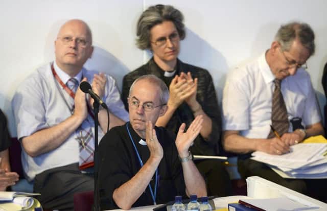The Archbishop of Canterbury (front) applauds a speaker during the Church of England's Synod session. Picture: PA