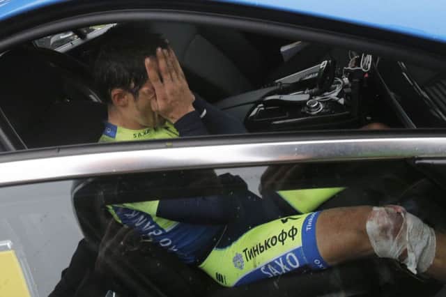 Alberto Contador covers his face after withdrawing from the Tour. Picture: AP