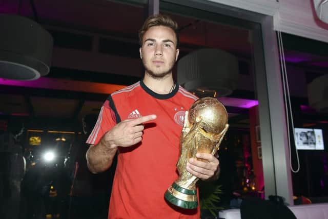 Matchwinner Mario Gotze shows off the trophy his goal secured. Picture: Reuters