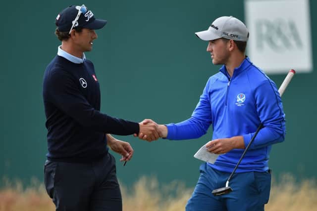 Bradley Neil shakes hands with the worlds No 1 golfer, Adam Scott, as he revels in the Open atmosphere. Picture: Getty