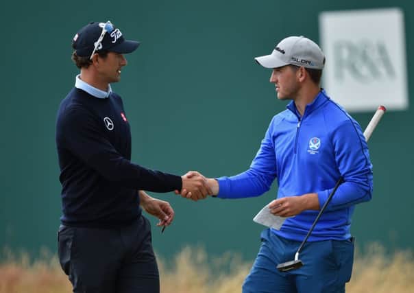 Bradley Neil shakes hands with the worlds No 1 golfer, Adam Scott, as he revels in the Open atmosphere. Picture: Getty