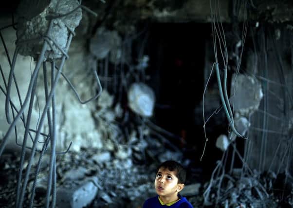 A Palestinian child wanders around a destroyed building in Beit Lahia, Gaza. Picture: Getty Images