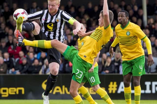 Celtic's Mikael Lustig, right, battles with Baldur Sigurdsson. Picture: SNS