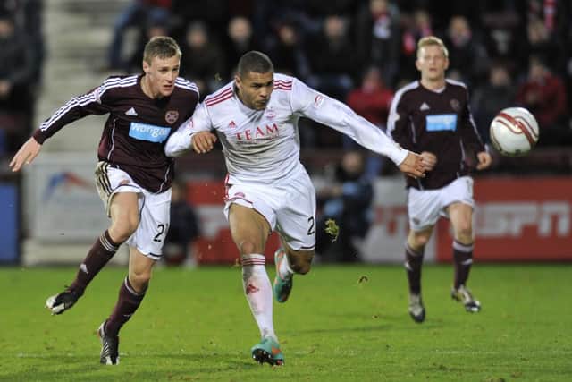 Josh Magennis takes on Kevin McHattie during the former's time at Aberdeen. Picture: Robert Perry