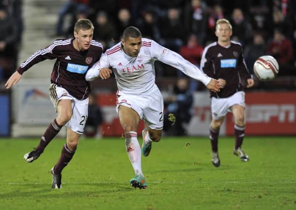 Josh Magennis takes on Kevin McHattie during the former's time at Aberdeen. Picture: Robert Perry