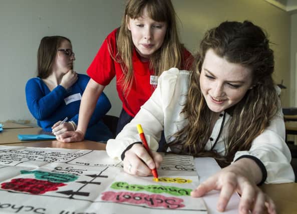 School pupils work with student mentors from Glasgow Caledonian University. Picture: Peter Devlin