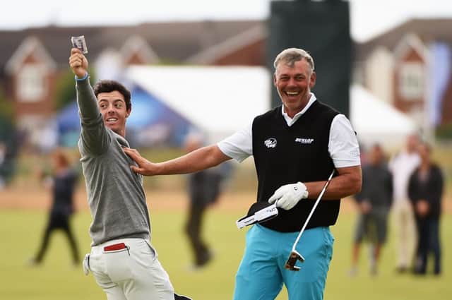 Rory McIlroy (L) celebrates winning a bet against Darren Clarke at Royal Liverpool yesterday. Picture: Getty