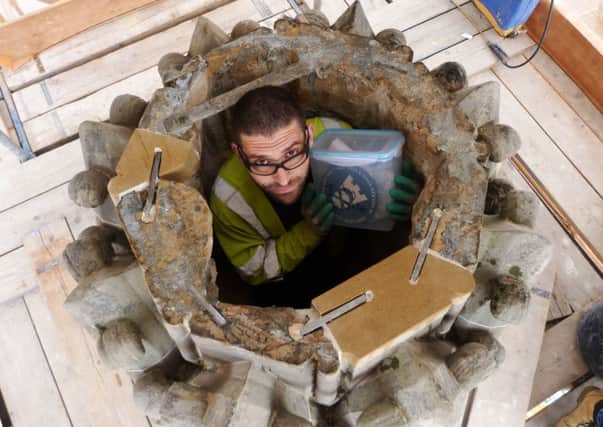 The stonemason prepares to place the capsule inside the fountain. Picture: Contributed