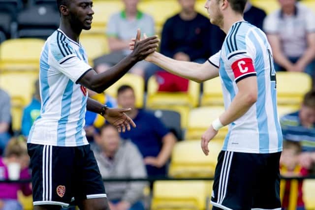 Prince Buaben, left, is congratulated by Hearts captain Danny Wilson. Picture: SNS