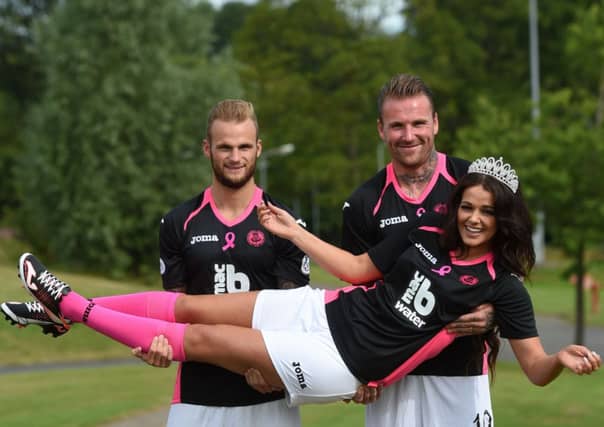 Ryan Stevenson, right, Kallum Higginbotham and Miss Glasgow West End Keri Mattinson show off the new Partick away kit. Picture: SNS